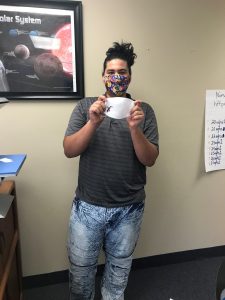 student holding finished mask product